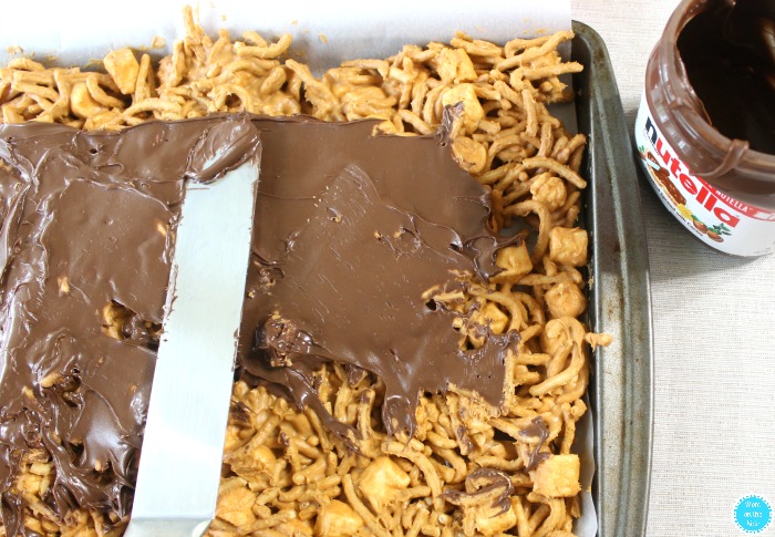 Spreading Nutella on top of Hopsotch Crunchy Bars